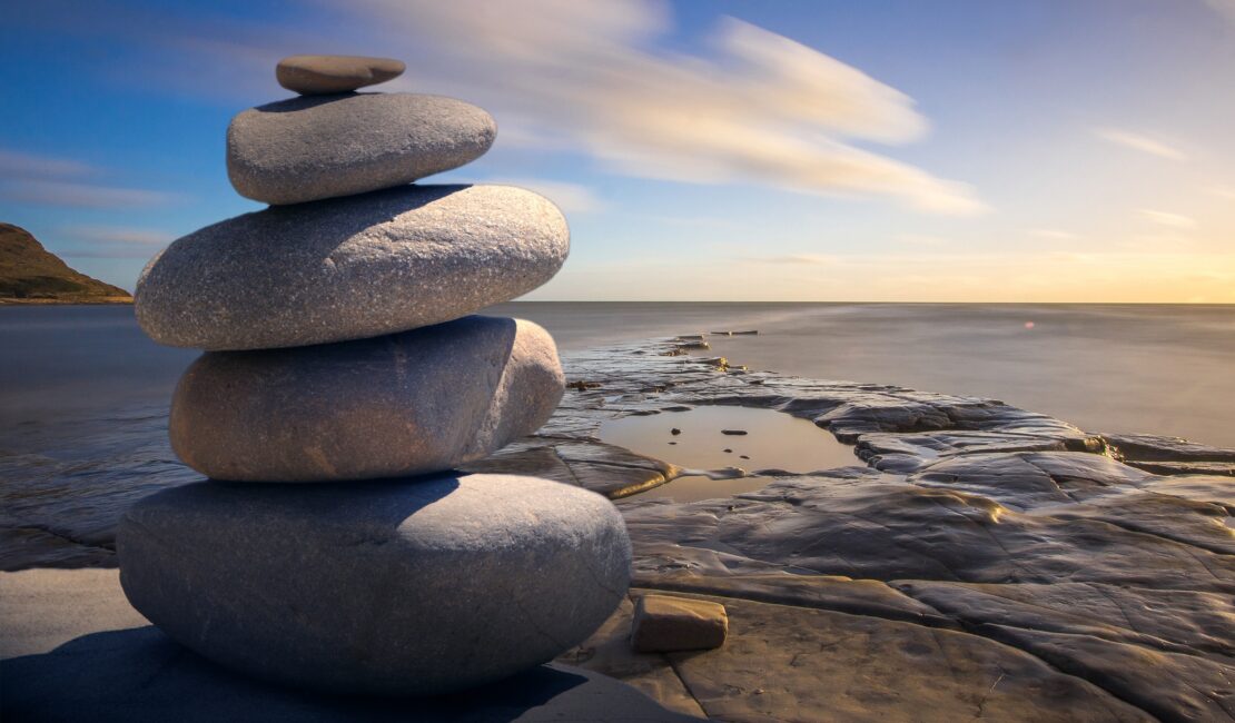 tower of stones with a relaxing backdrop of the ocean and blue skys
