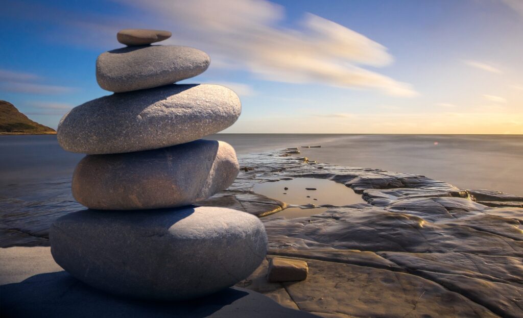 tower of stones with a relaxing backdrop of the ocean and blue skys