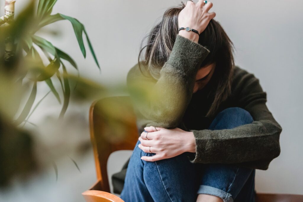 woman sitting in chair struggling with depression and anxiety