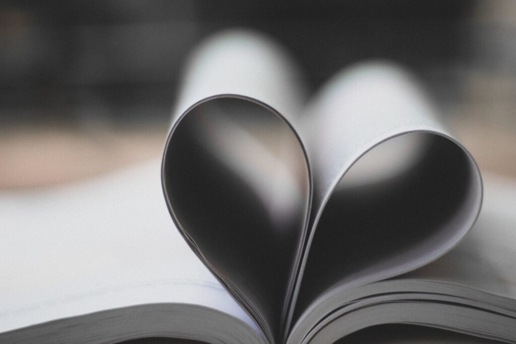 A picture of a Book with the pages folded as to create a heart