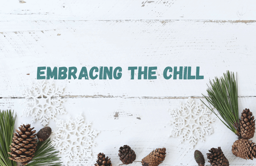 white sign, winter wreath at bottom with acorns that says "Embracing The Chill"
