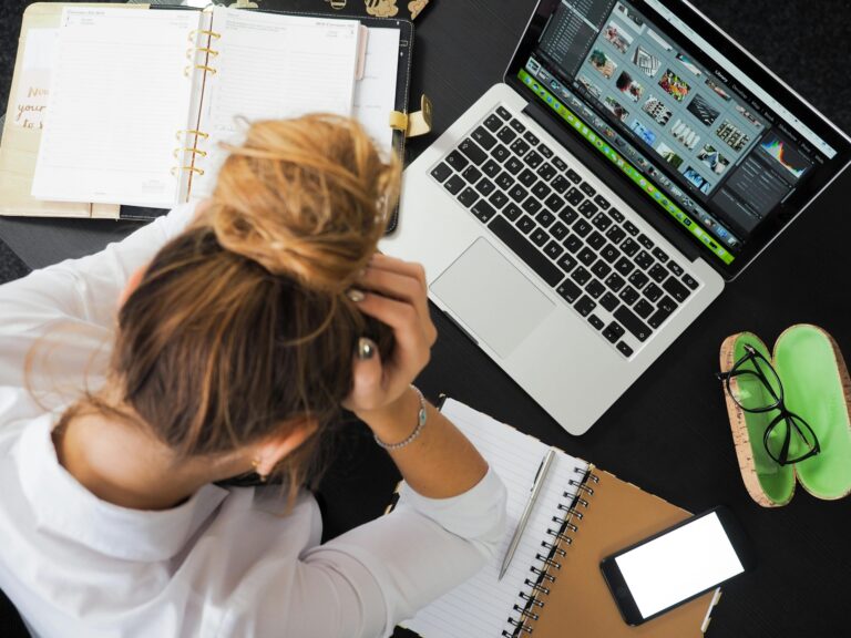 Overwhelmed Entrepreneur , hand in head, over a laptop