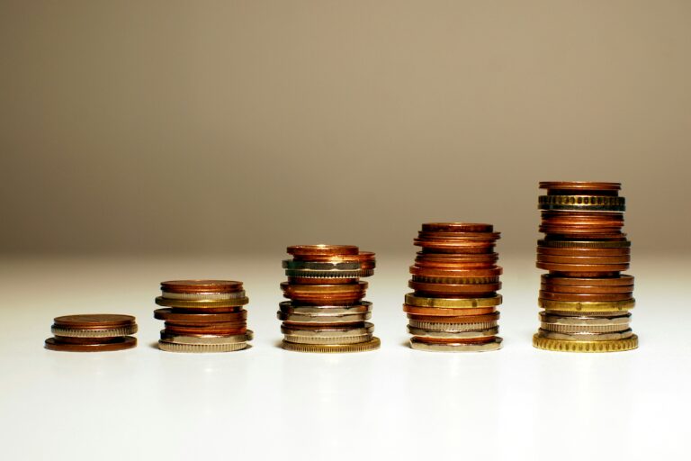 Stacks of coins increasing in height, symbolizing the measurable financial returns and market outperformance associated with conscious leadership and stakeholder-driven business models.